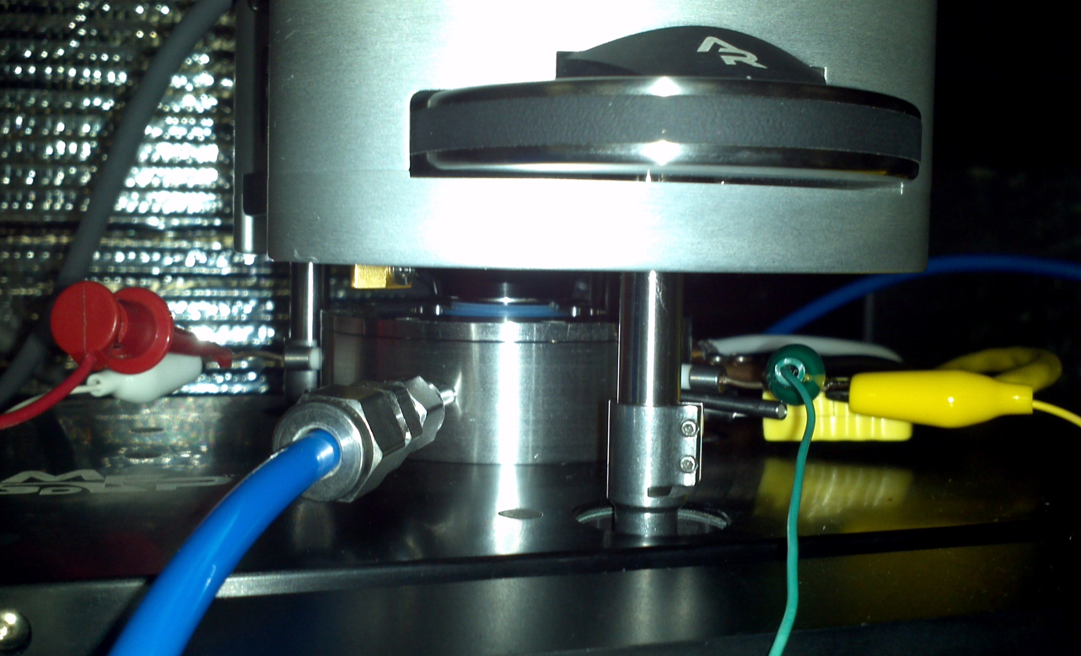 The lab's in-situ AFM environmental chamber, wired for operando measurements: AFM scan head, cantilever holder, oxygen inlet, electrical feedthroughs, heater power, and thermocouple.